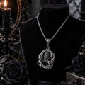 Ornate spider pendant necklace on a black display bust