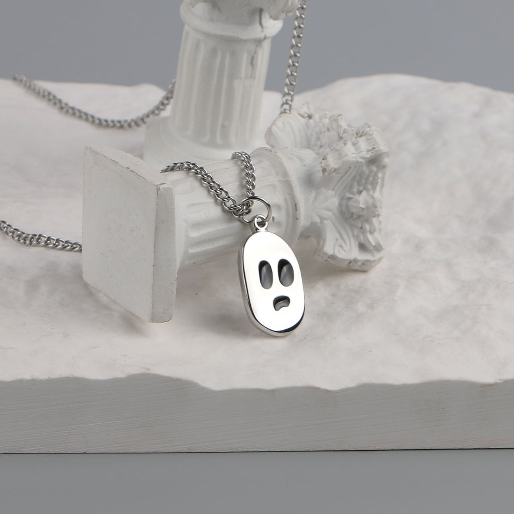 Ghost face pendant necklace displayed on white props