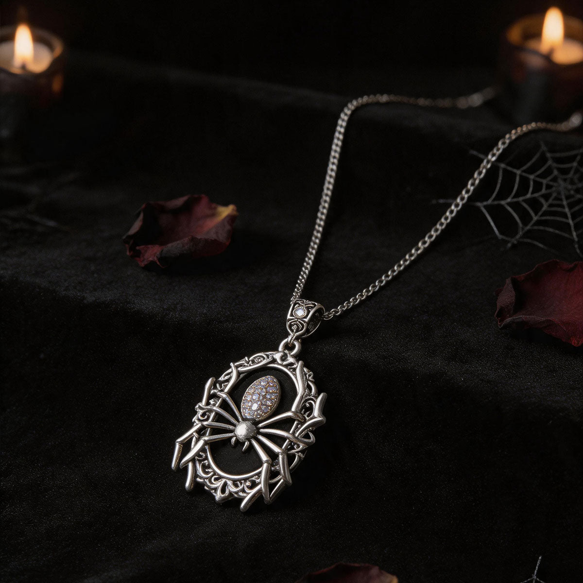 Silver-tone spider cameo necklace displayed on dark fabric
