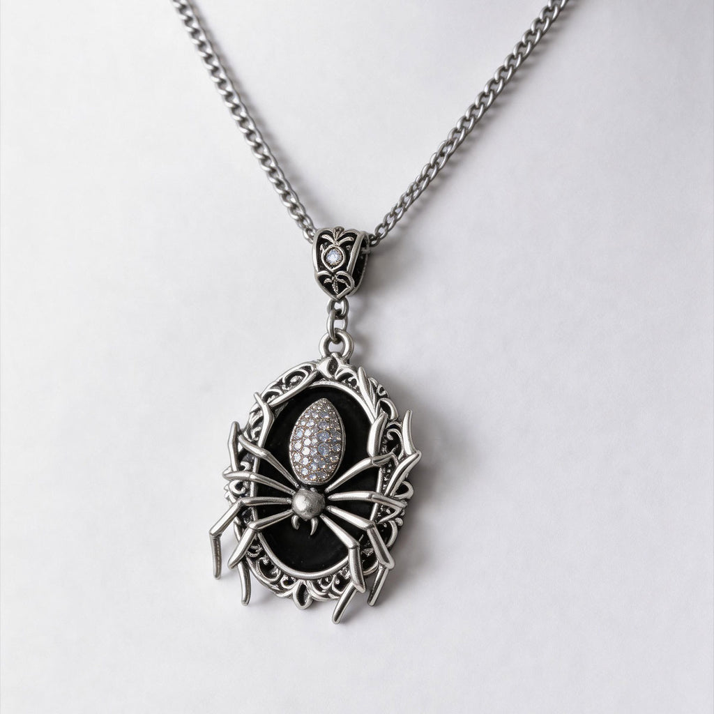 Man wearing a spider cameo pendant necklace over a black top