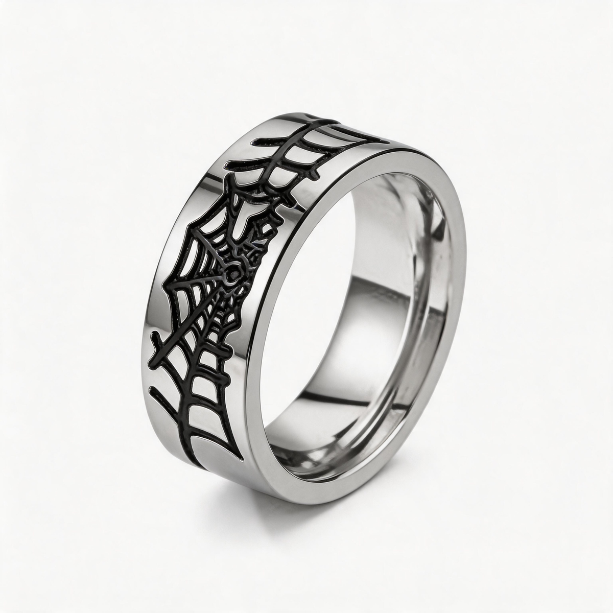 Silver-tone ring with dark spiderweb pattern against a black background