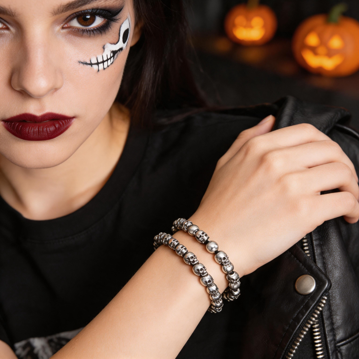 Silver-tone skull bead bracelets displayed against a dark background