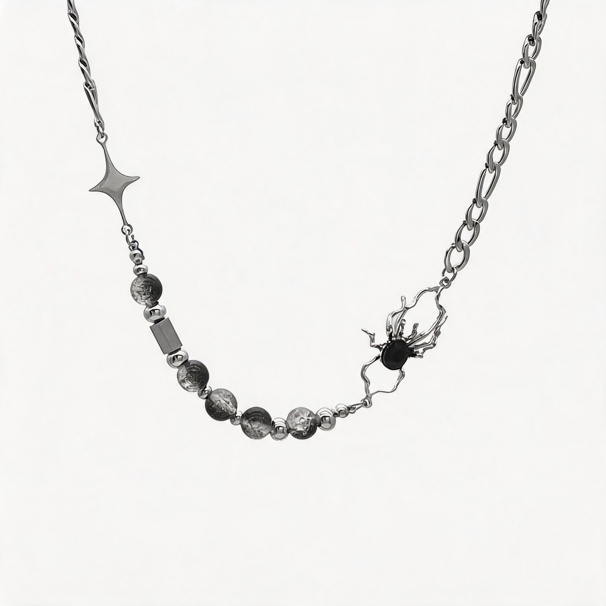 Asymmetric silver-tone spider necklace with crackle-pattern beads on a white background